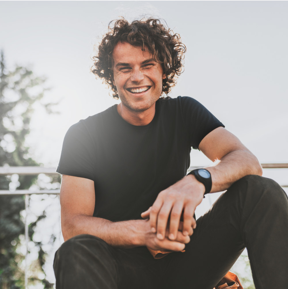 Low view shot of happy stylish young man wears black t-shirt and